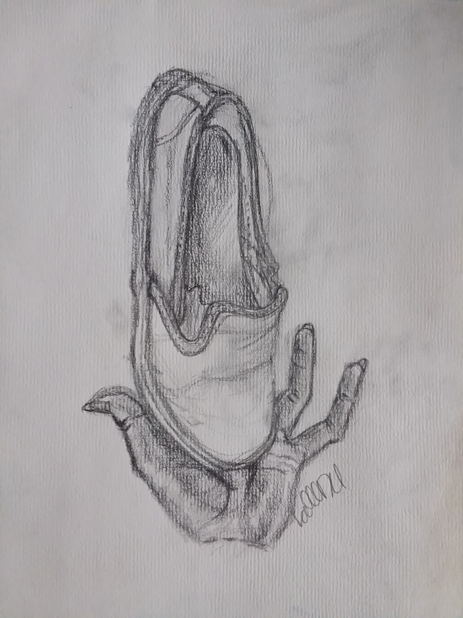 Drawing of shoe balanced upright in palm of hand.